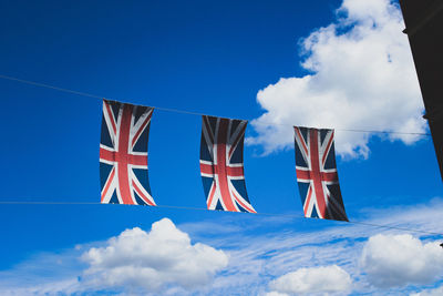 Low angle view of flag against blue sky