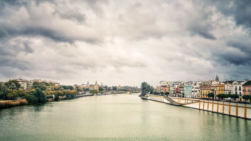 View of bridge over river against cloudy sky