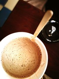 Close-up of coffee cup on wooden table