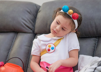 Pretty girl in her halloween costume on the couch