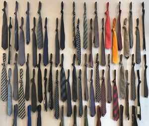 Full frame shot of various neckties hanging on wall for sale in store