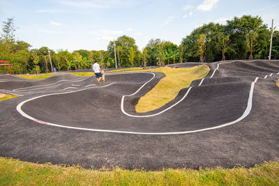 High angle view of road amidst trees against sky