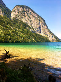 Scenic view of sea and mountains against sky