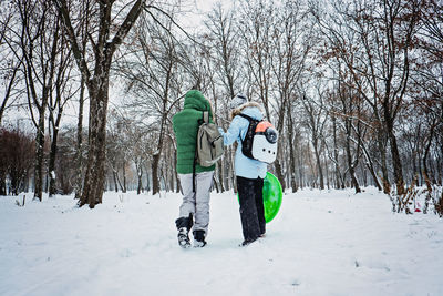 Outdoors winter activities for family, friends. happy family, friends, two women, two boy kids and