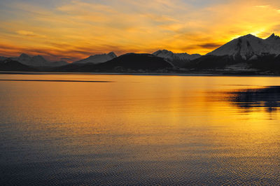 Scenic view of beagle channel against mountains during sunset