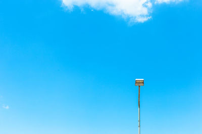 Low angle view of street light against blue sky