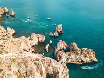 Ocean landscape with rocks and cliffs at lagos bay coast in algarve, portugal