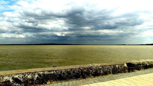 Scenic view of sea against cloudy sky