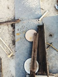 High angle view of broken shoes on floor