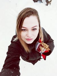 Close-up portrait of smiling young woman during winter