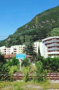 Information sign on mountain against clear sky