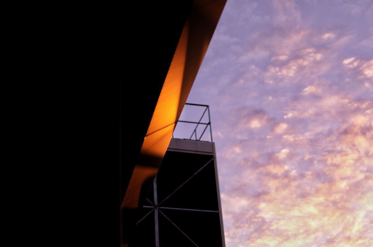 LOW ANGLE VIEW OF BUILDING AGAINST SKY DURING SUNSET