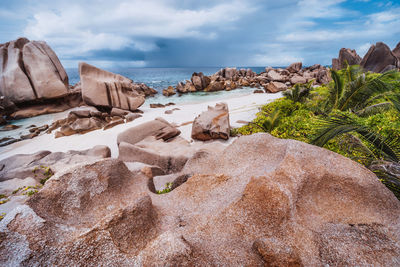 Rocks on beach against sky