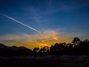 Scenic view of silhouette mountains against sky at sunset