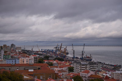 High angle view of townscape by sea against sky