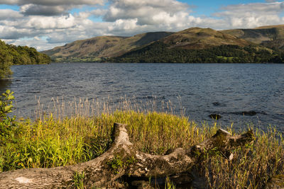 Scenic view of lake and mountains against sky