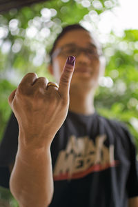 Close-up of woman with ink on finger