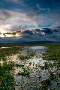 Scenic view of lake against sky during sunset