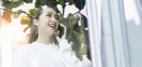 Portrait of a smiling young woman looking away