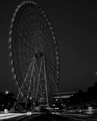 Low angle view of ferris wheel against sky at night