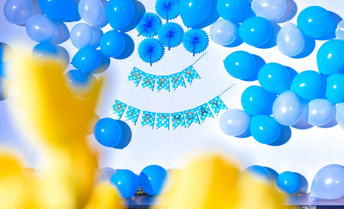 Low angle view of multi colored balloons