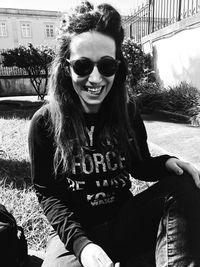 Portrait of smiling young woman sitting outdoors