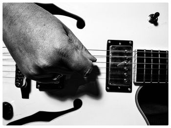 Cropped image of man playing guitar