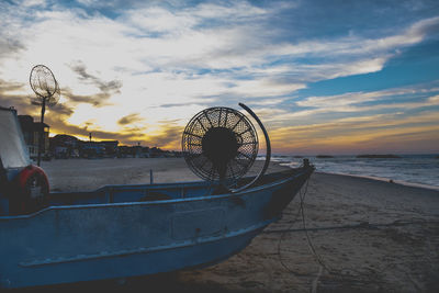 Ferris wheel on beach against sky