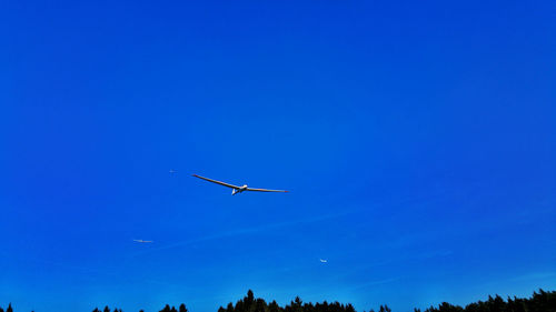 Low angle view of airplane flying in sky