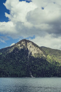 Scenic view of sea and mountains against sky