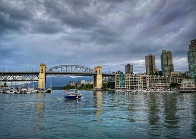View of bridge over river against cloudy sky