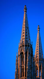 Low angle view of cathedral against clear blue sky in vienna, austria.