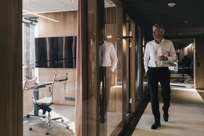 Man looking through window