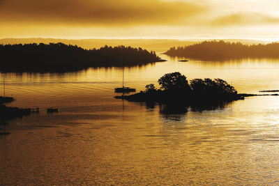 First light of the morning bathes the skerries of stockholm in a deep yellow