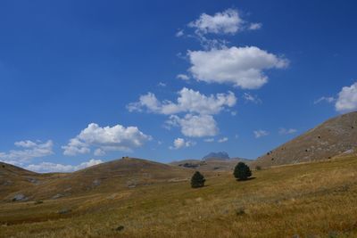 Scenic view of mountains against cloudy sky