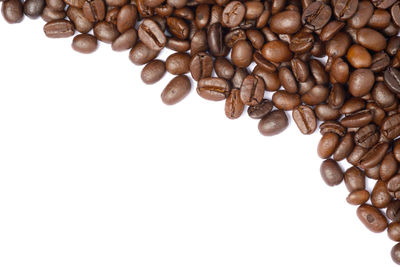 Close-up of coffee beans against white background