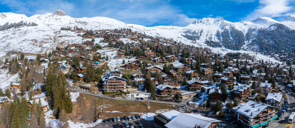 Aerial view of snow covered mountains against sky