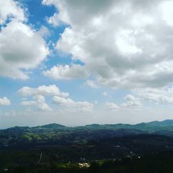 Scenic view of mountains against cloudy sky