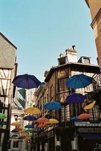 Buildings in city against clear blue sky