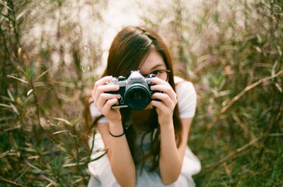 Photographer photographing through camera