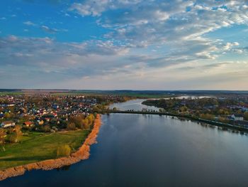 High angle view of river by townscape against sky