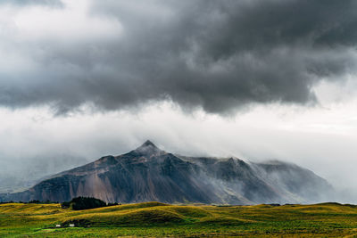 Scenic view of agricultural field against storm clouds