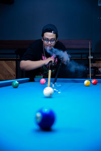 Midsection of man playing pool