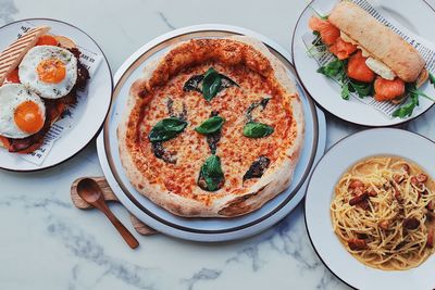 High angle view of pizza served on table