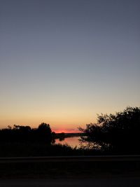Scenic view of silhouette landscape against clear sky at sunset