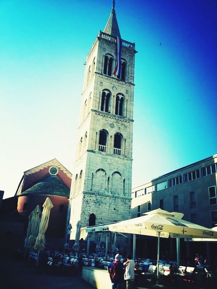 architecture, building exterior, built structure, clear sky, low angle view, blue, religion, place of worship, church, tower, spirituality, famous place, travel destinations, cathedral, history, tall - high, clock tower, tourism