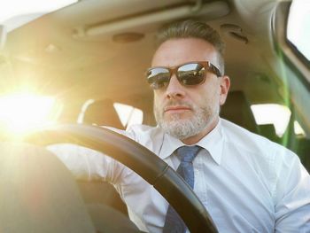 Man wearing sunglasses while driving car
