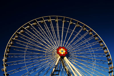 Low angle view of illuminated ferris wheel at night