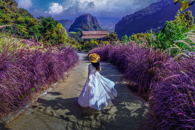 Rear view of woman with purple umbrella