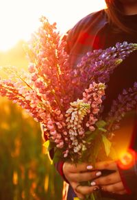 Close-up of woman with pink flower bouquet
